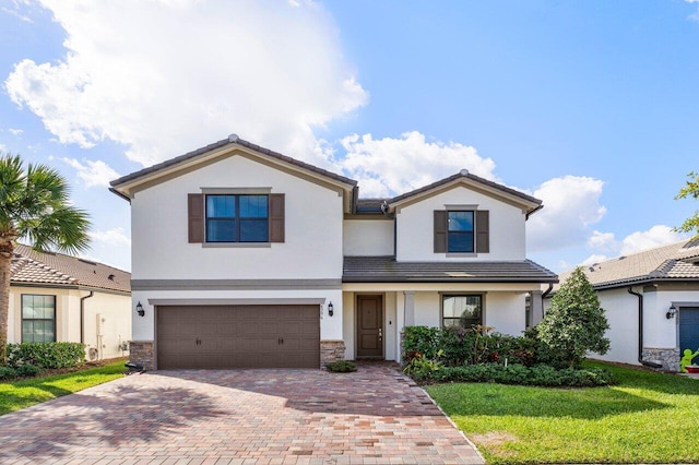 view of front of property featuring a garage, stone siding, decorative driveway, and stucco siding