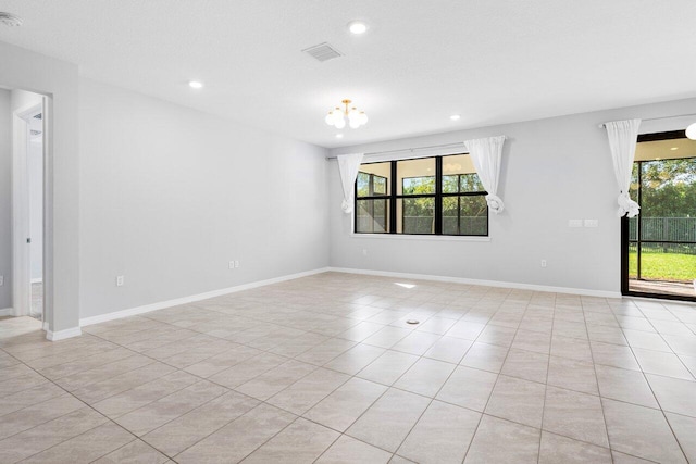 empty room featuring a healthy amount of sunlight, visible vents, and baseboards