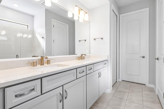 bathroom with double vanity, tile patterned flooring, a sink, and a shower stall