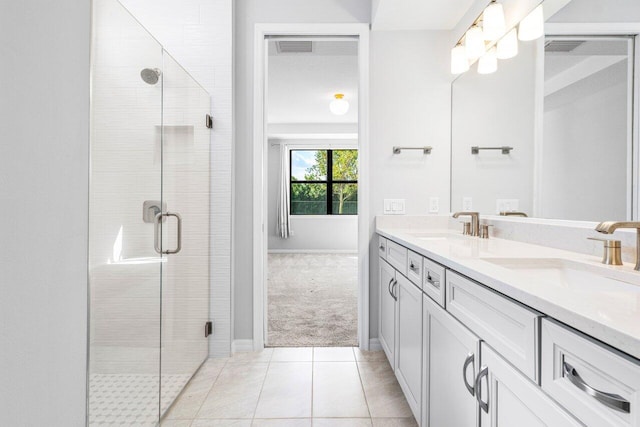 bathroom featuring visible vents, a sink, a shower stall, and tile patterned floors