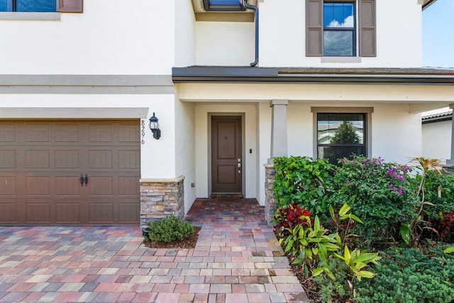 property entrance featuring stone siding and stucco siding