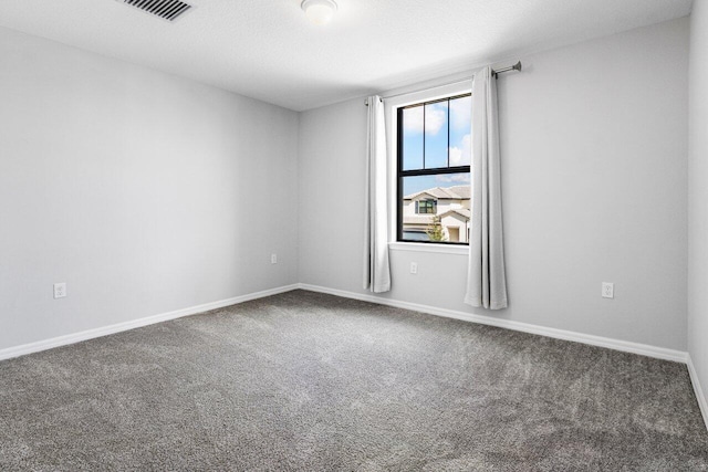 spare room with baseboards, visible vents, a textured ceiling, and carpet flooring