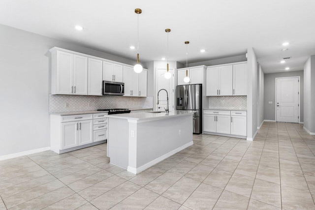 kitchen featuring a center island with sink, light countertops, appliances with stainless steel finishes, white cabinets, and a sink