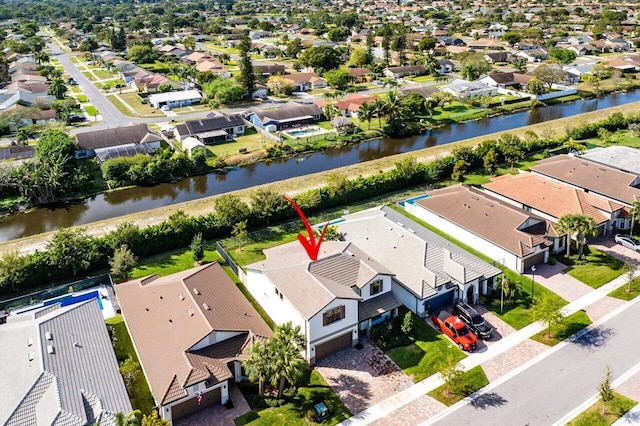 drone / aerial view featuring a water view and a residential view