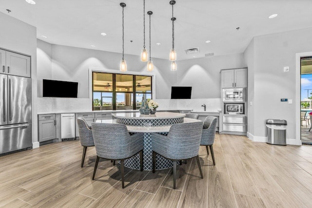 dining room featuring light wood-type flooring, visible vents, and recessed lighting