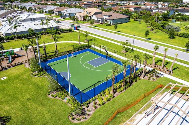 view of basketball court with community basketball court, fence, and a residential view