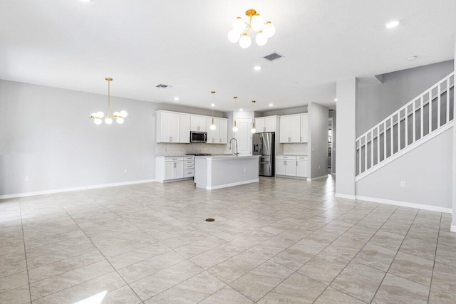 unfurnished living room with a notable chandelier, visible vents, stairway, a sink, and baseboards