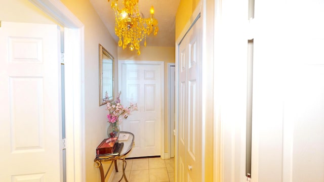 413 European Ln, Fort Pierce, FL 34982 - hallway featuring light tile patterned floors and a chandelier