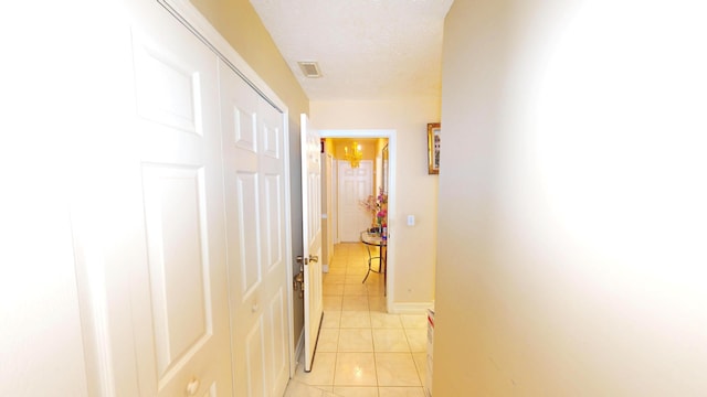 413 European Ln, Fort Pierce, FL 34982 - hall featuring light tile patterned floors, baseboards, visible vents, and a textured ceiling