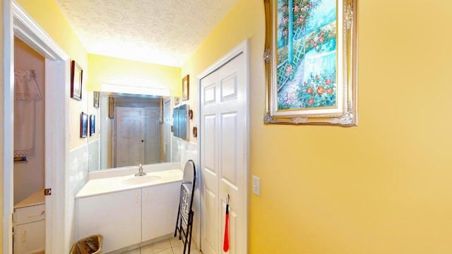 413 European Ln, Fort Pierce, FL 34982 - bathroom with vanity, tile patterned flooring, and a textured ceiling