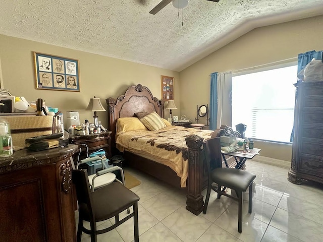 bedroom featuring vaulted ceiling, light tile patterned floors, a textured ceiling, and a ceiling fan