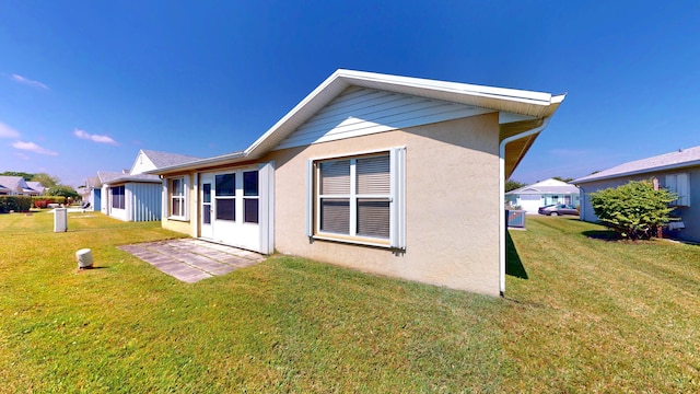 413 European Ln, Fort Pierce, FL 34982 - back of house with stucco siding and a yard
