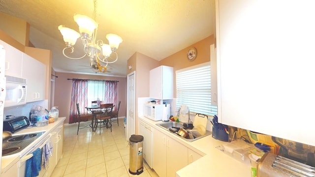 413 European Ln, Fort Pierce, FL 34982 - kitchen with a sink, white appliances, an inviting chandelier, light countertops, and light tile patterned floors