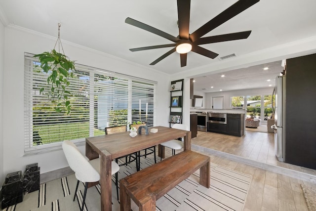 dining area with light wood-type flooring, recessed lighting, visible vents, and ornamental molding