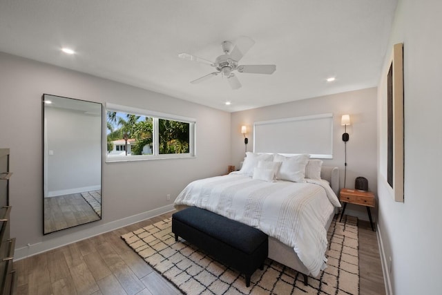 bedroom featuring ceiling fan, baseboards, wood finished floors, and recessed lighting