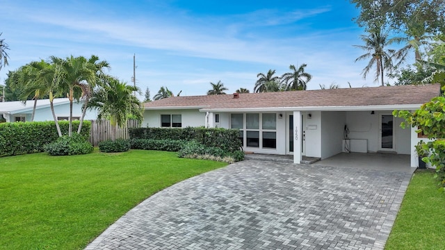 ranch-style house with a front yard, fence, and stucco siding