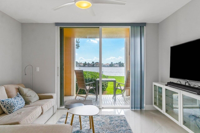 living room featuring baseboards, a wall of windows, a wealth of natural light, and a ceiling fan