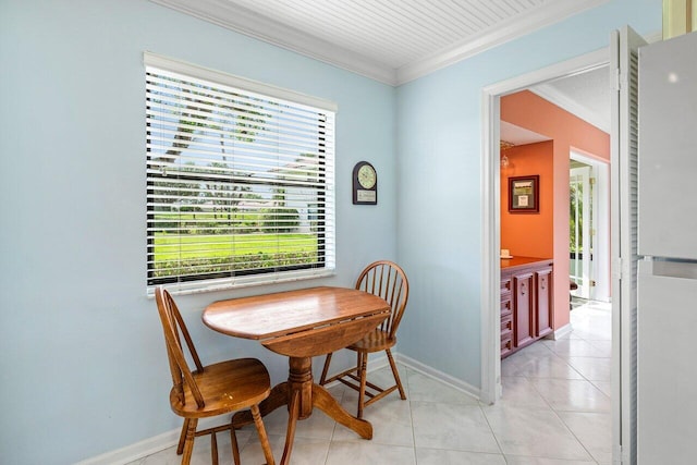 dining space with crown molding, baseboards, and light tile patterned floors