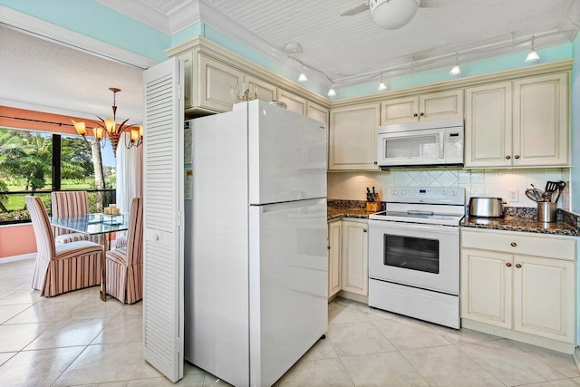 kitchen with white appliances, backsplash, cream cabinetry, and light tile patterned flooring