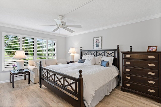 bedroom featuring a textured ceiling, light wood-type flooring, and crown molding