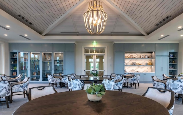 dining room with built in features, high vaulted ceiling, visible vents, and a notable chandelier