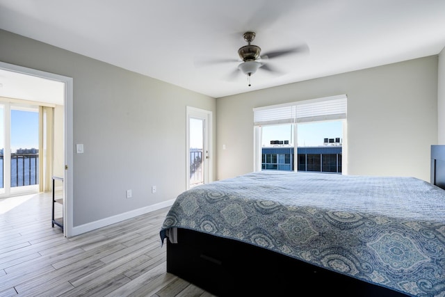 bedroom with a ceiling fan, baseboards, and wood finished floors