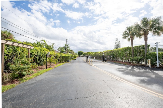 view of road with a gate and a gated entry