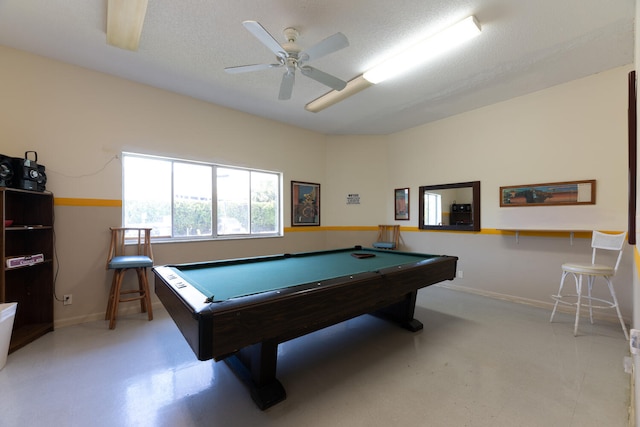 game room featuring billiards, a textured ceiling, and baseboards