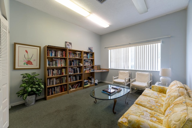 carpeted living room with lofted ceiling, baseboards, and a textured ceiling