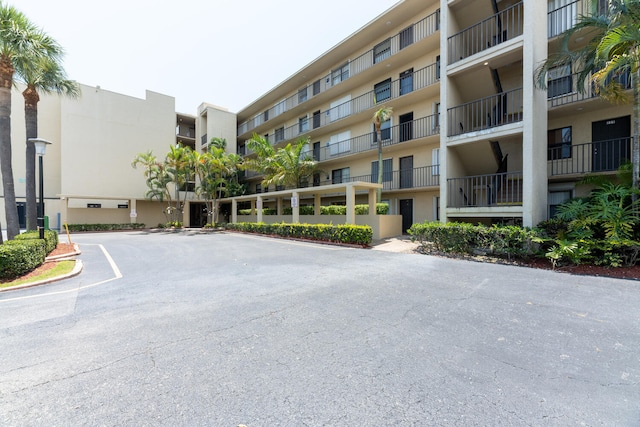 view of building exterior featuring uncovered parking