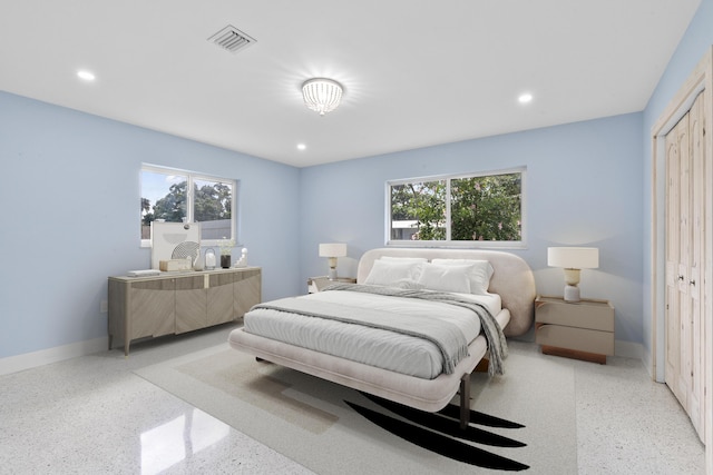 bedroom with light speckled floor, recessed lighting, a closet, visible vents, and baseboards