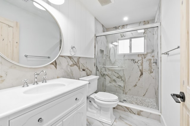 bathroom featuring marble finish floor, a marble finish shower, visible vents, toilet, and vanity