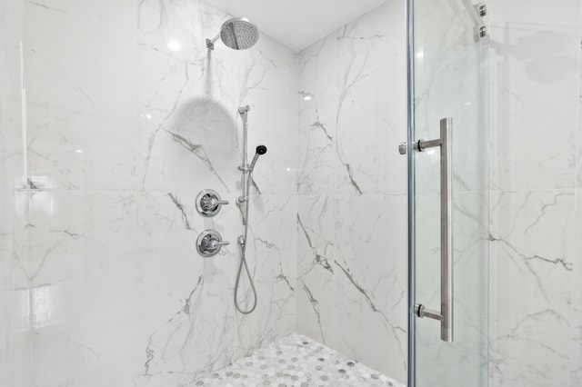 bathroom with a marble finish shower