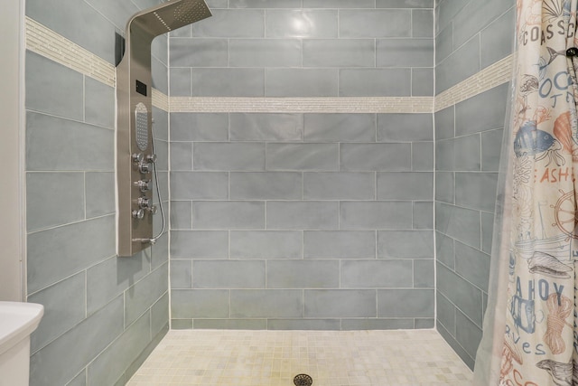 bathroom with tiled shower