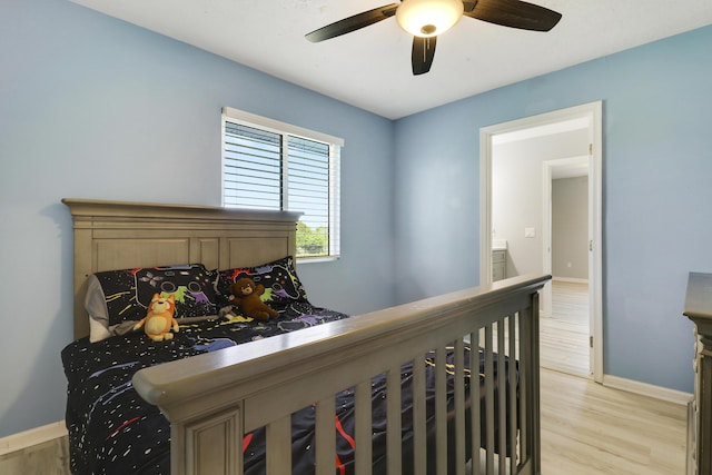 hall with light wood finished floors, an upstairs landing, and baseboards