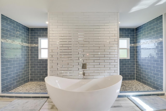 full bathroom with a soaking tub, tile patterned flooring, and walk in shower