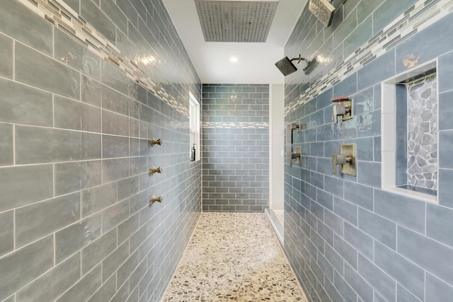 bathroom with a tile shower and recessed lighting