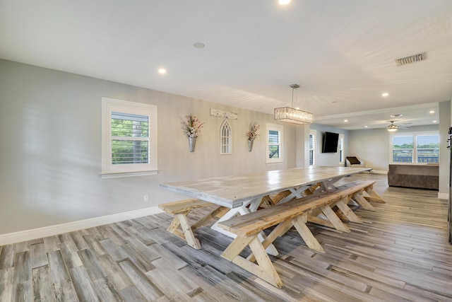 dining area featuring light wood-style flooring, recessed lighting, visible vents, baseboards, and an inviting chandelier