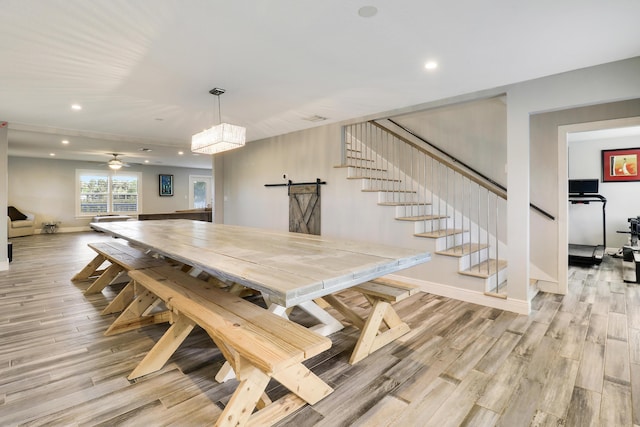 dining space featuring light wood-style flooring, stairway, baseboards, and recessed lighting