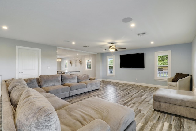 living area with a healthy amount of sunlight, light wood-style floors, visible vents, and recessed lighting