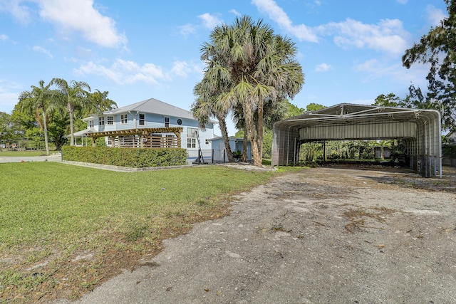 view of front of home with a carport, driveway, and a front lawn