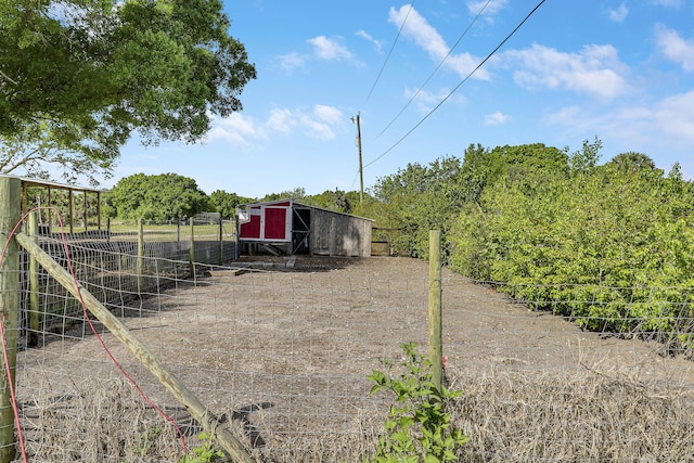 view of yard with an outdoor structure and fence