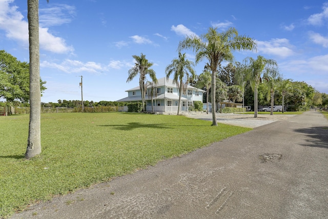 exterior space featuring driveway and a lawn