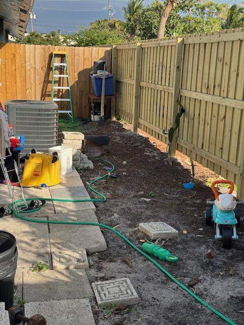 view of yard with a fenced backyard and cooling unit