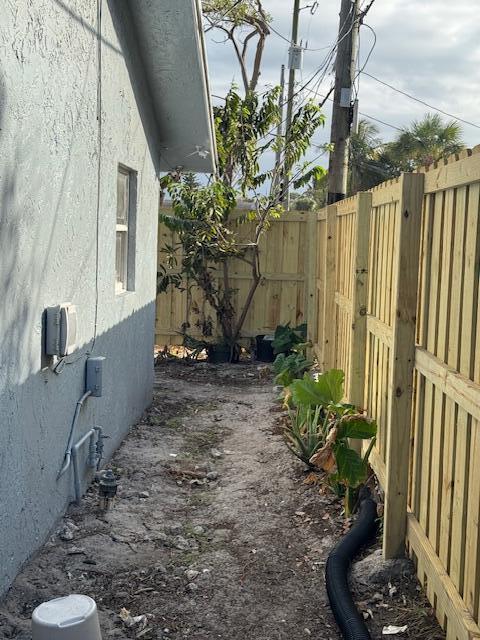 view of home's exterior with a fenced backyard and stucco siding