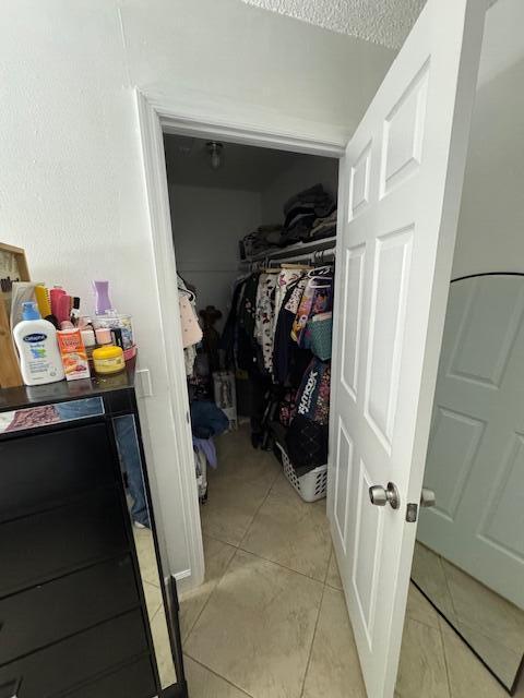 spacious closet with light tile patterned flooring