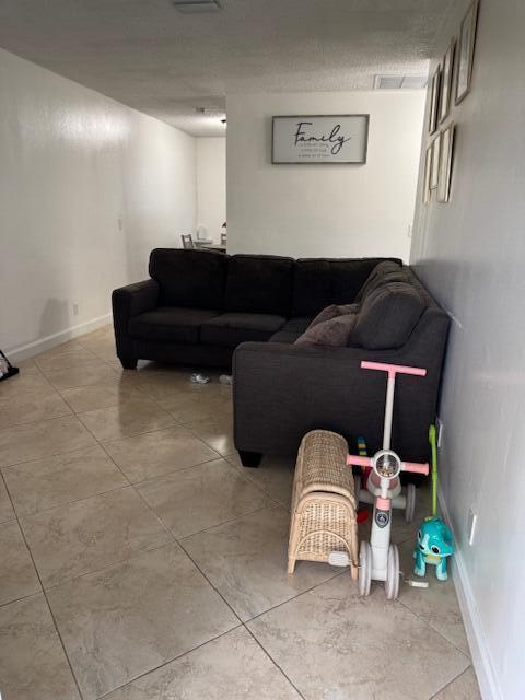 living room with visible vents and baseboards