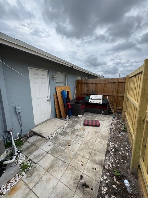 view of patio / terrace featuring fence