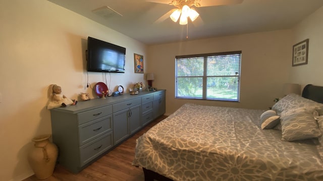 bedroom featuring visible vents, dark wood-type flooring, and a ceiling fan