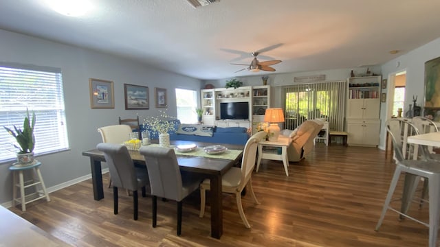 dining area featuring plenty of natural light, wood finished floors, a ceiling fan, and baseboards